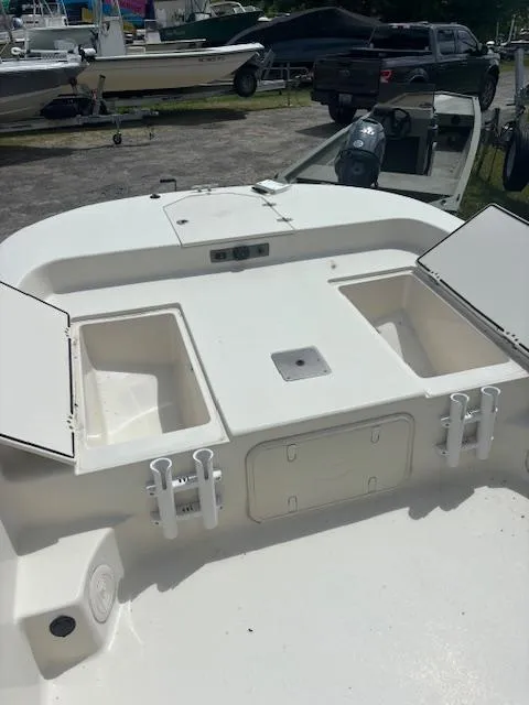 Slide: The Image of 2021 Carolina Skiff 23 LS boat deck with storage compartments and rod holders. - 7