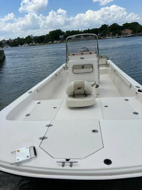 Slide: The Image of 2021 Carolina Skiff 23 LS boat on water, featuring spacious deck and seating. - 9