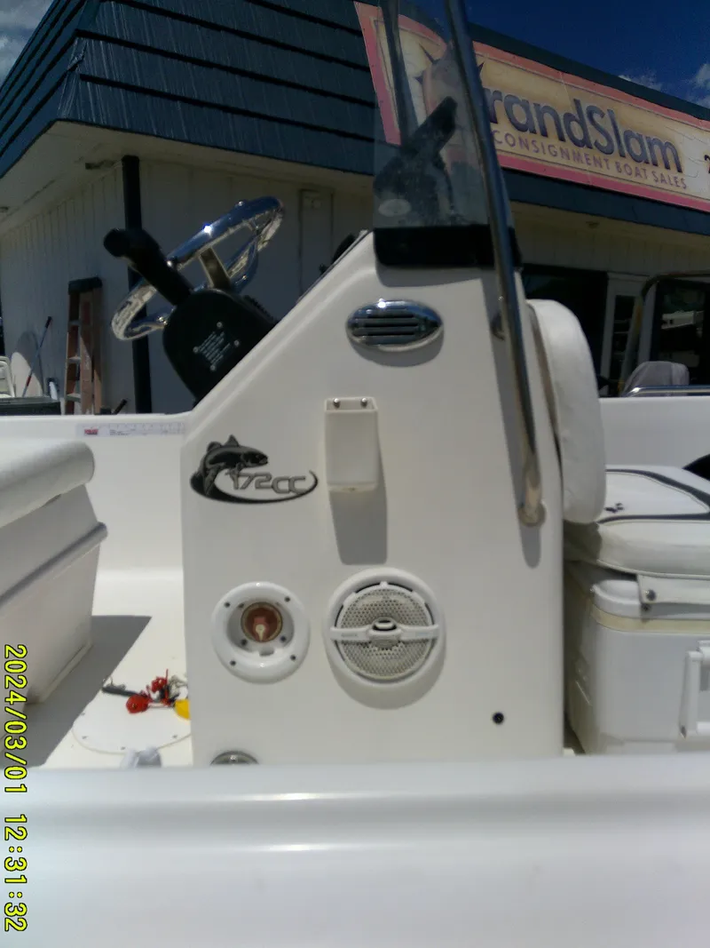 Slide: The Image of 2011 Sea Fox 172 CC boat console with steering wheel and controls, parked outside a store. - 10