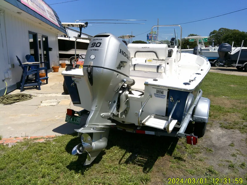 Slide: The Image of 2011 Sea Fox 172 CC boat with Honda 90 engine on trailer, parked outdoors. - 14