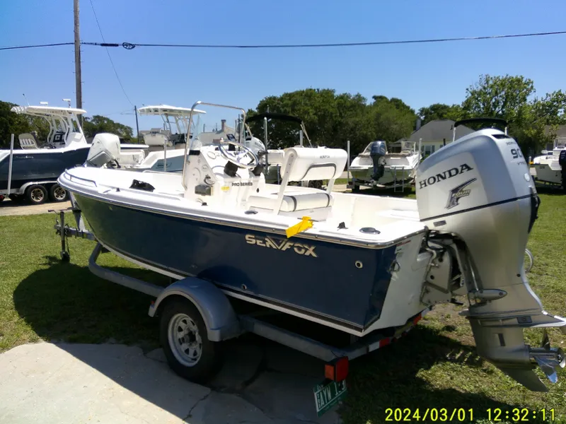 Slide: The Image of 2011 Sea Fox 172 CC boat with Honda outboard motor on trailer, parked outdoors. - 16