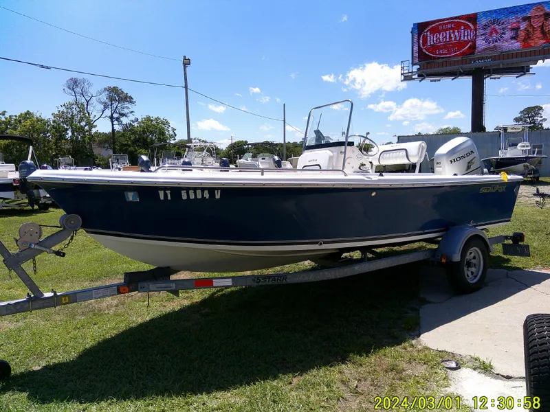 Slide: The Image of 2011 Sea Fox 172 CC boat on trailer, parked outdoors under clear blue sky. - 4