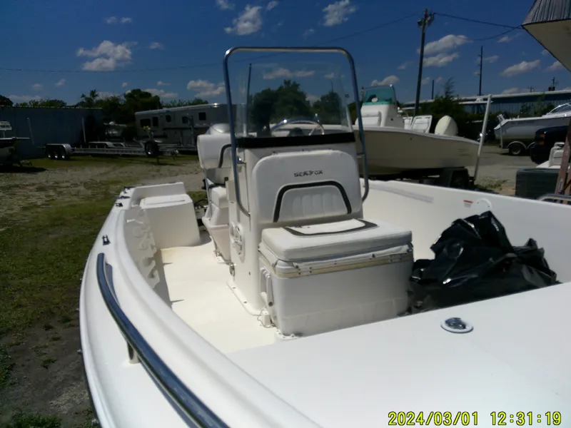 Slide: The Image of 2011 Sea Fox 172 CC boat with center console, parked outdoors under a clear sky. - 7