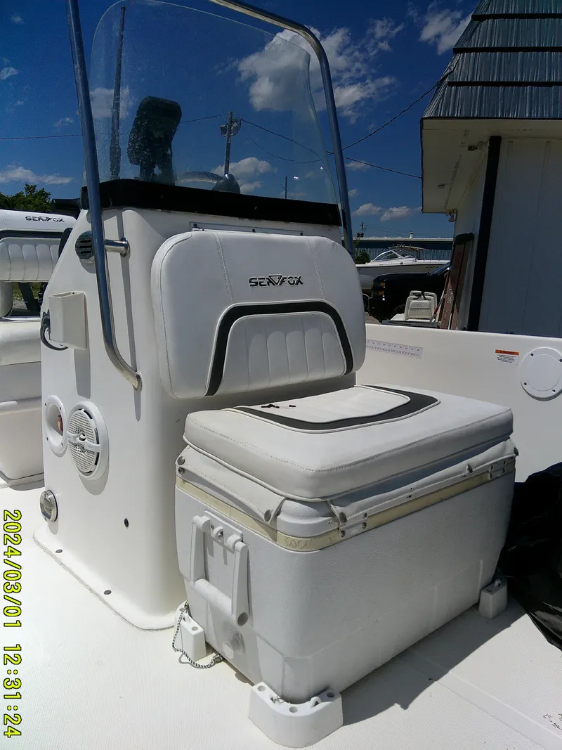Slide: The Image of 2011 Sea Fox 172 CC boat console with seating, under clear blue sky. - 8