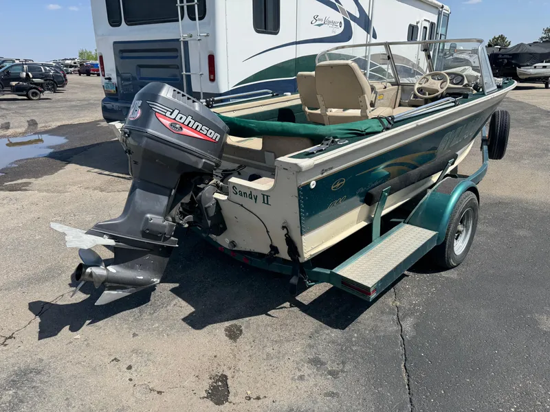 Slide: The Image of 1999 Sylvan 1700 Pro Select boat with Johnson outboard motor on trailer. - 3