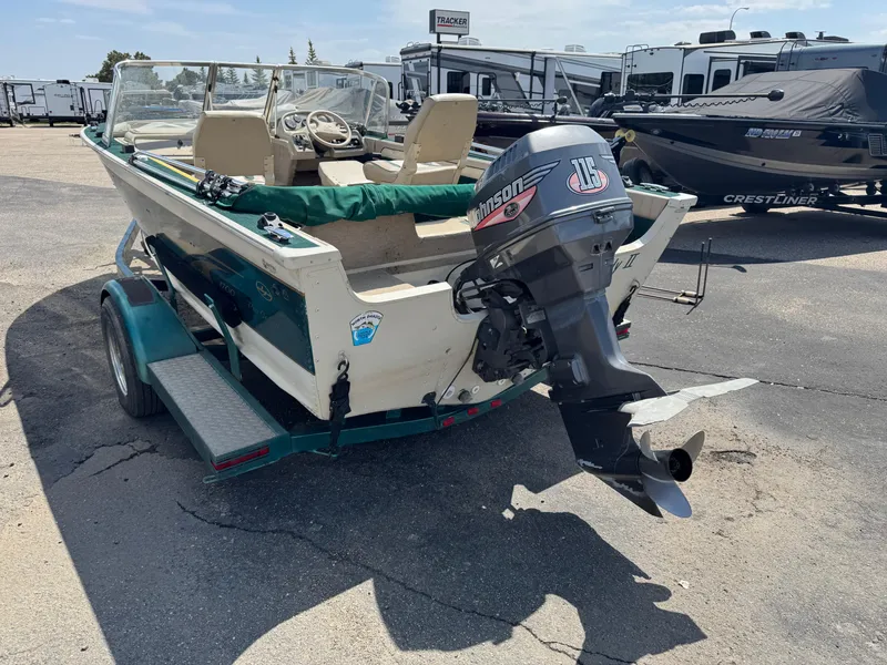 Slide: The Image of 1999 Sylvan 1700 Pro Select boat with outboard motor on trailer. - 4