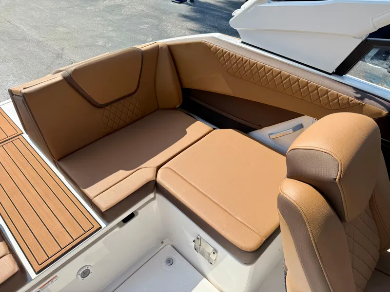 Slide: The Image of 2025 Yamaha Boats 222SD interior with tan leather seating and wood accents. - 11