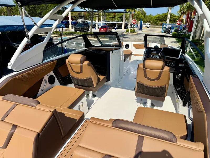 Slide: The Image of 2025 Yamaha Boats 222SD interior with tan seating and modern dashboard. - 13