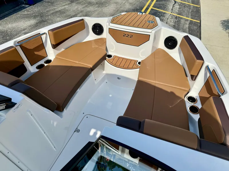 Slide: The Image of 2025 Yamaha Boats 222SD interior with brown seating and modern design. - 18