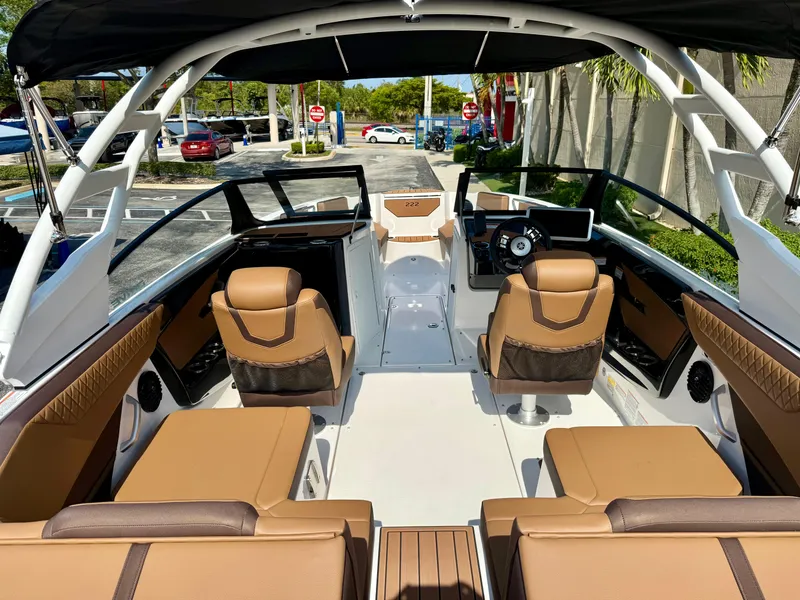 Slide: The Image of 2025 Yamaha Boats 222SD interior with tan seating and modern dashboard. - 8
