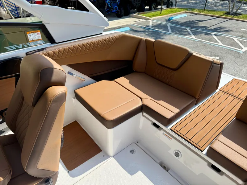 Slide: The Image of 2025 Yamaha Boats 222SD interior with tan seating and wood accents. - 9