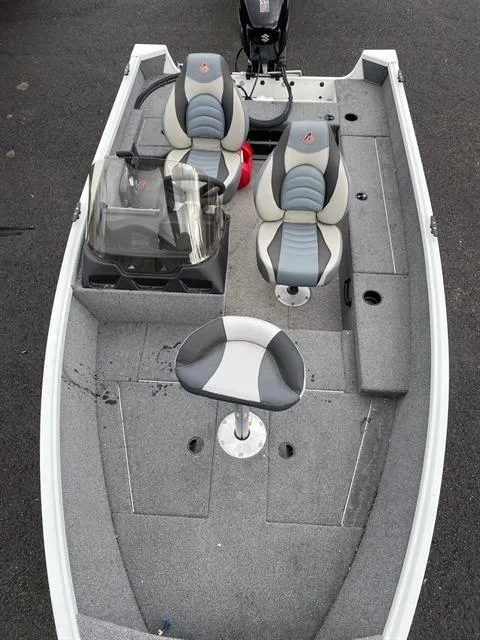 Slide: The Image of 2022 Alumacraft Escape 145 CS boat with gray seating and console, viewed from above. - 2