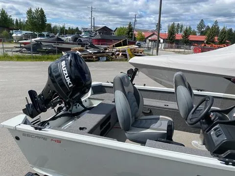 Slide: The Image of 2022 Alumacraft Escape 145 CS boat with Suzuki outboard motor, parked outdoors. - 4