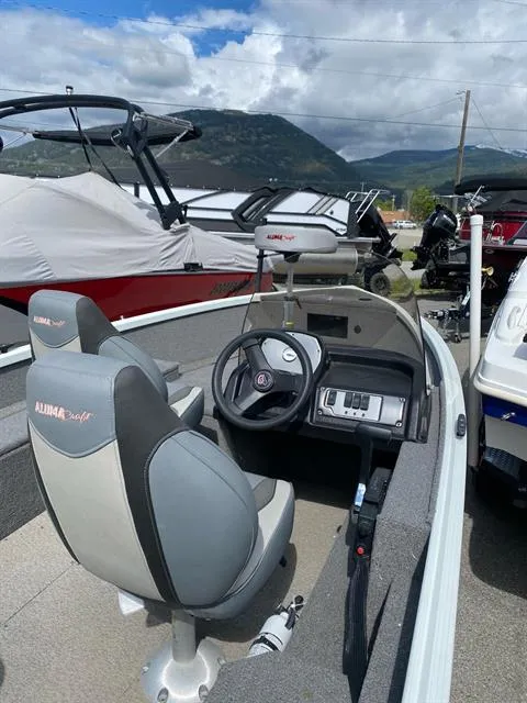 Slide: The Image of 2022 Alumacraft Escape 145 CS boat interior with steering wheel and seating. - 5