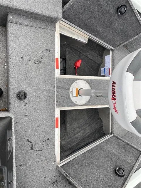 Slide: The Image of 2022 Alumacraft Escape 145 CS boat interior with seating and storage compartments. - 8