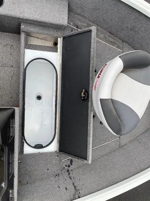 Slide: The Image of 2022 Alumacraft Escape 145 CS boat interior with storage compartment and seat. - 9