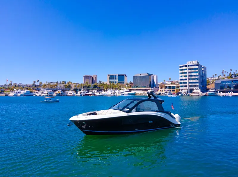 Slide: The Image of 2022 Sea Ray Sundancer 370 OB yacht on a sunny marina backdrop. - 12