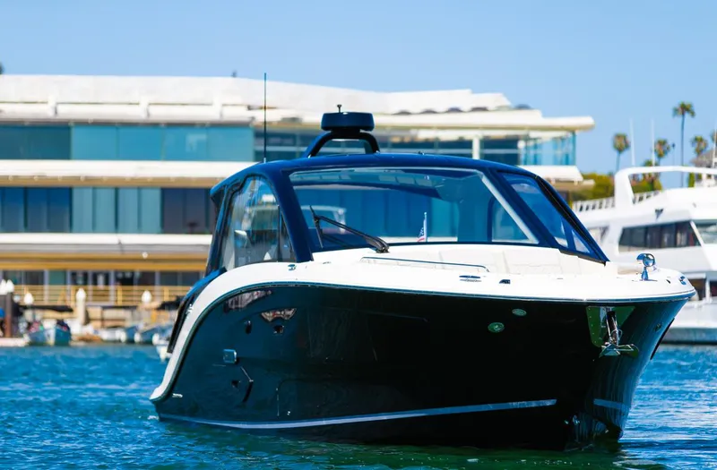 Slide: The Image of 2022 Sea Ray Sundancer 370 OB yacht docked near modern waterfront building. - 15