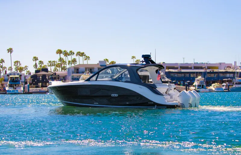 Slide: The Image of 2022 Sea Ray Sundancer 370 OB cruising in a sunny marina. - 23