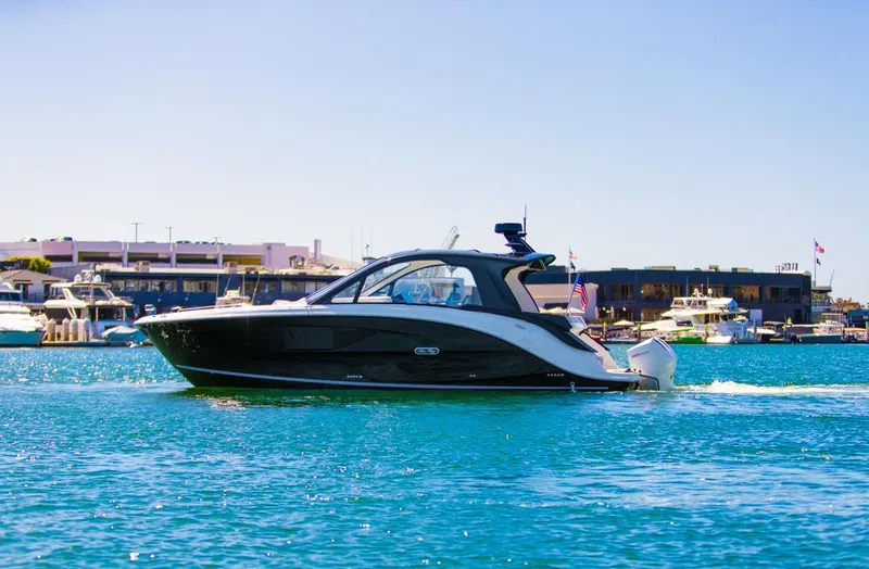 Slide: The Image of 2022 Sea Ray Sundancer 370 OB cruising on clear blue water. - 24