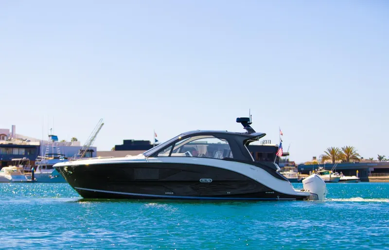 Slide: The Image of 2022 Sea Ray Sundancer 370 OB cruising on a sunny day in a marina. - 25