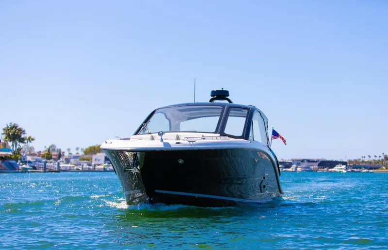 Slide: The Image of 2022 Sea Ray Sundancer 370 OB cruising on clear blue water under a sunny sky. - 29