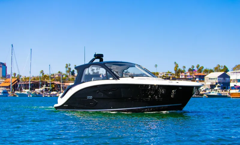 Slide: The Image of 2022 Sea Ray Sundancer 370 OB cruising on a sunny day in a marina. - 3
