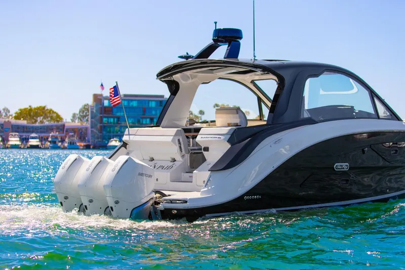 Slide: The Image of 2022 Sea Ray Sundancer 370 OB cruising on clear blue water, rear view. - 30