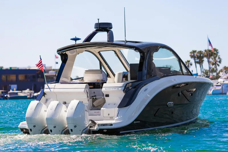 Slide: The Image of 2022 Sea Ray Sundancer 370 OB cruising on clear blue water. - 31