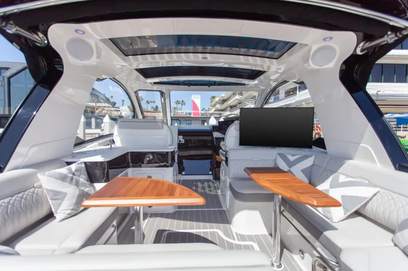 Slide: The Image of 2022 Sea Ray Sundancer 370 OB interior with modern seating and wooden tables. - 37