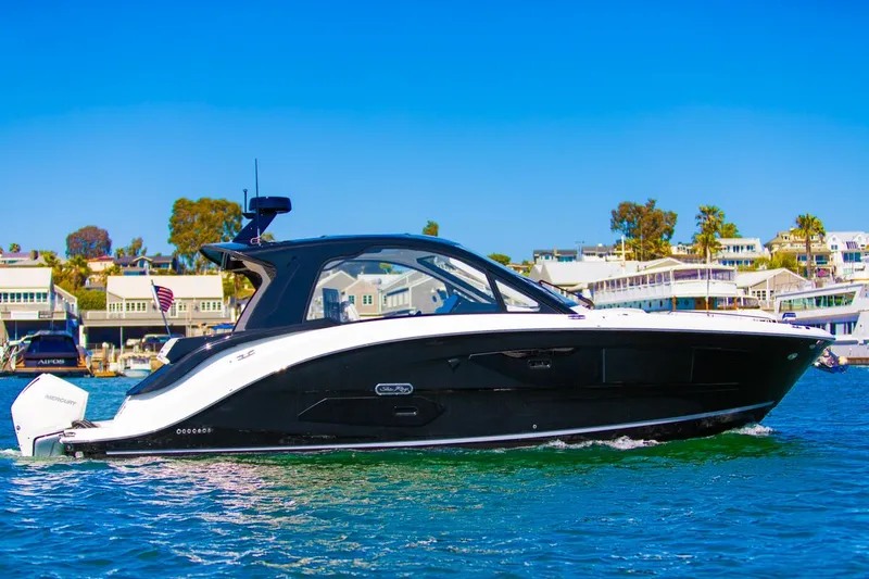Slide: The Image of 2022 Sea Ray Sundancer 370 OB cruising on a sunny day near waterfront homes. - 4