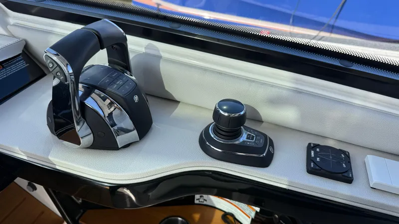 Slide: The Image of 2022 Sea Ray Sundancer 370 OB helm controls with joystick and throttle. - 42