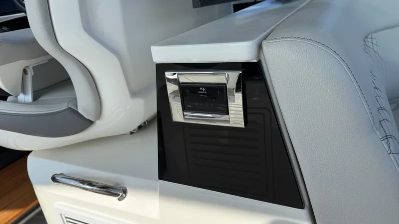 Slide: The Image of 2022 Sea Ray Sundancer 370 OB interior detail with modern control panel and luxurious seating. - 46