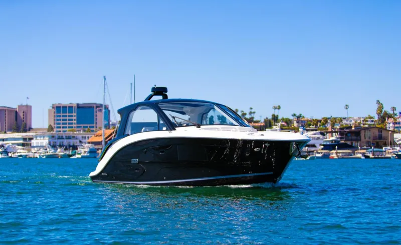Slide: The Image of 2022 Sea Ray Sundancer 370 OB cruising in a marina under clear blue skies. - 9
