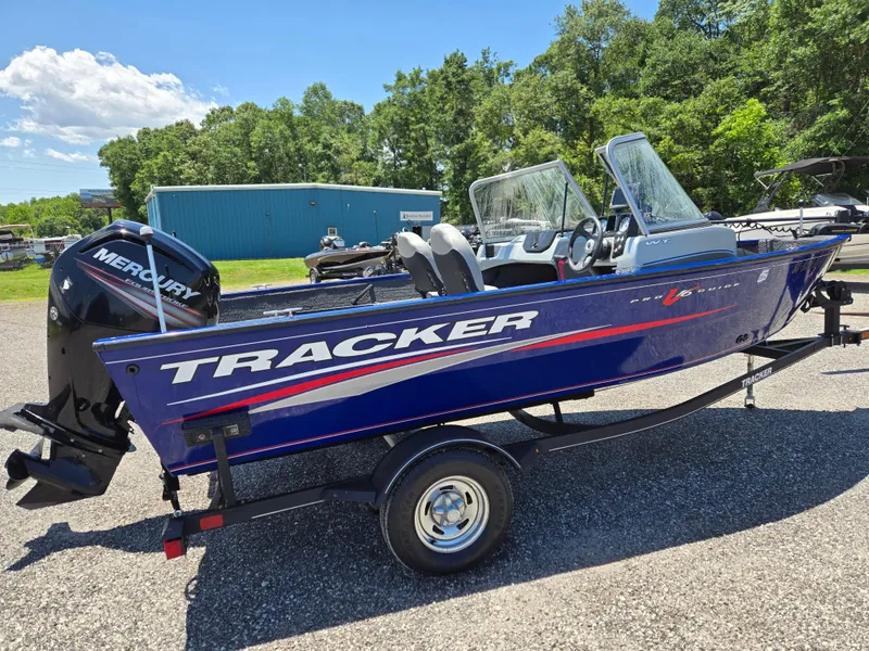 Slide: The Image of 2018 Tracker Pro Guide V-16 WT boat with Mercury engine on trailer, parked outdoors. - 4