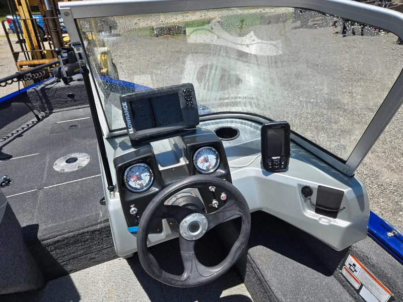 Slide: The Image of 2018 Tracker Pro Guide V-16 WT boat dashboard with steering wheel and navigation equipment. - 8