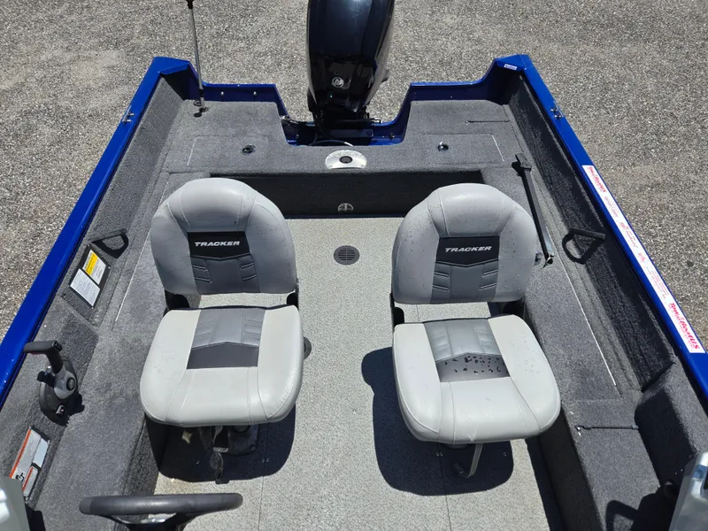 Slide: The Image of 2018 Tracker Pro Guide V-16 WT boat interior with two gray seats. - 9