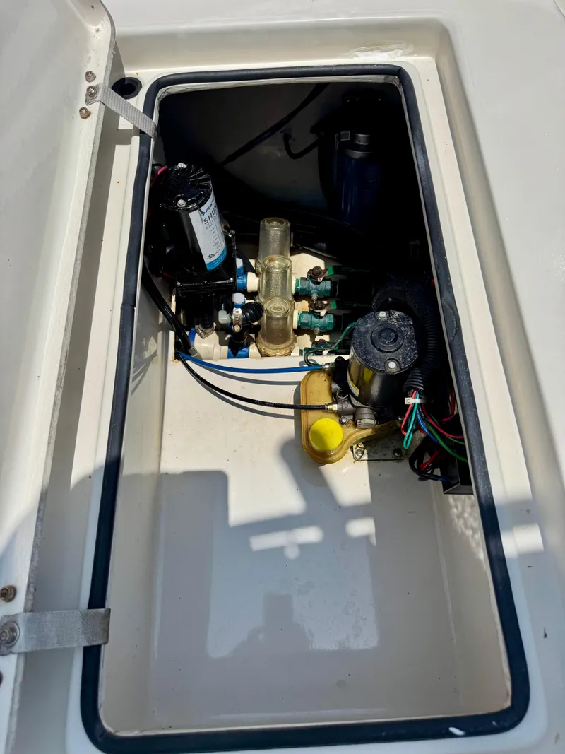 Slide: The Image of 2011 Pathfinder 2400 Tournament Edition boat compartment with pumps and wiring. - 10