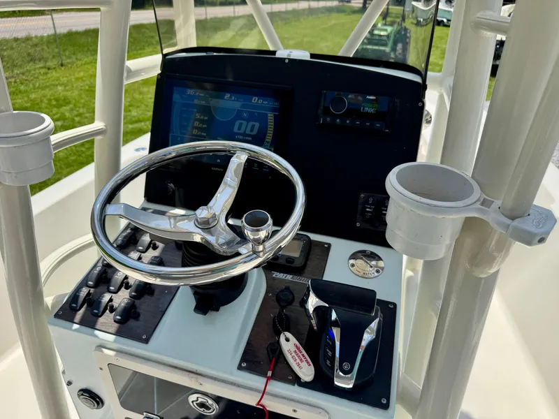 Slide: The Image of 2011 Pathfinder 2400 Tournament Edition boat console with steering wheel and controls. - 13
