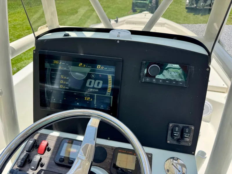 Slide: The Image of Control panel of 2011 Pathfinder 2400 Tournament Edition boat with steering wheel and digital display. - 14