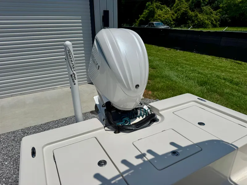 Slide: The Image of 2011 Pathfinder 2400 Tournament Edition boat with outboard motor, parked near a garage. - 16