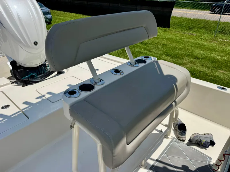 Slide: The Image of Pathfinder 2400 Tournament Edition 2011 boat seat with cup holders, outdoor setting. - 17
