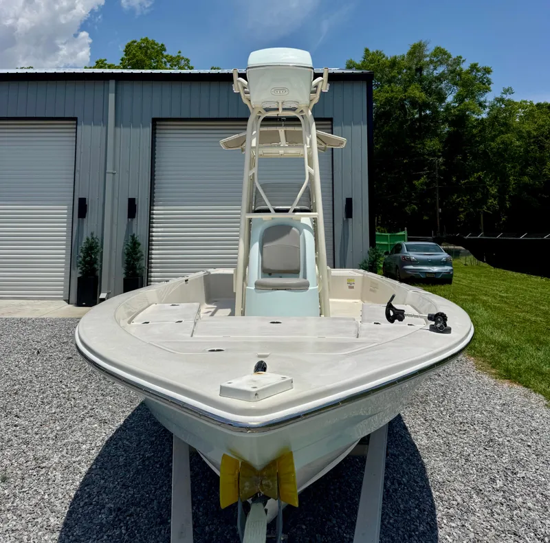 Slide: The Image of 2011 Pathfinder 2400 Tournament Edition boat on gravel, near a garage. - 3