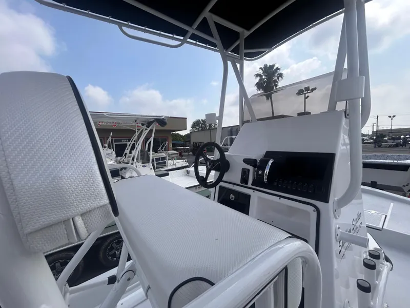Slide: The Image of 2025 Shallow Stalker CAT211PRO boat interior with steering wheel and seating. - 10