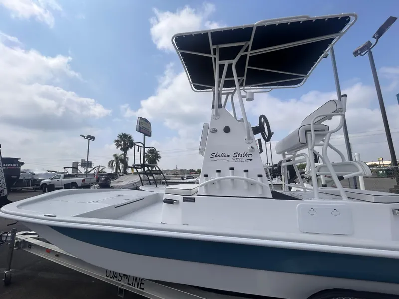 Slide: The Image of 2025 Shallow Stalker CAT211PRO boat with T-top, displayed outdoors under cloudy sky. - 3