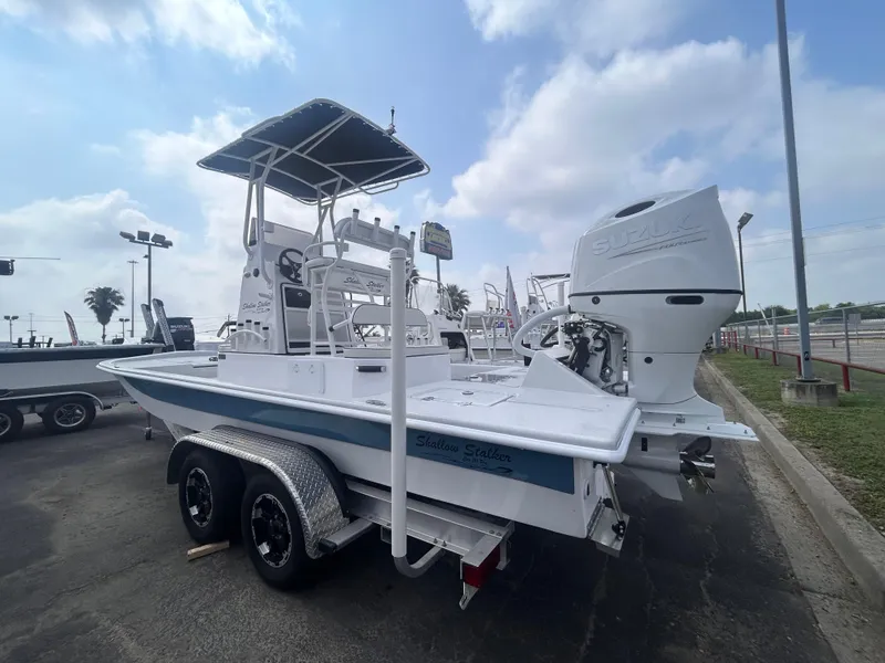 Slide: The Image of 2025 Shallow Stalker CAT211PRO boat on trailer, outdoor display, cloudy sky background. - 4
