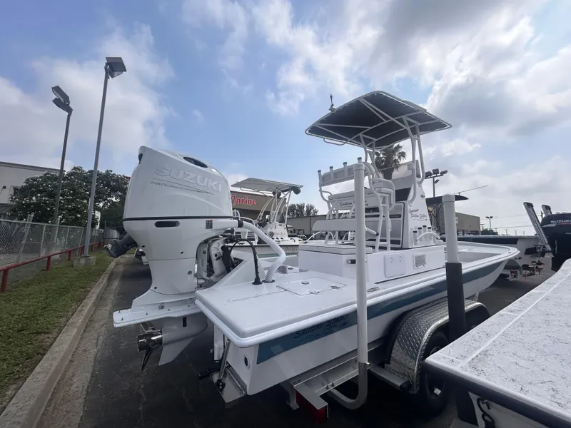 Slide: The Image of 2025 Shallow Stalker CAT211PRO boat with Suzuki outboard motor on trailer, outdoor display. - 5