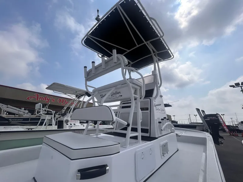Slide: The Image of 2025 Shallow Stalker CAT211PRO boat with T-top, displayed outdoors under cloudy sky. - 6