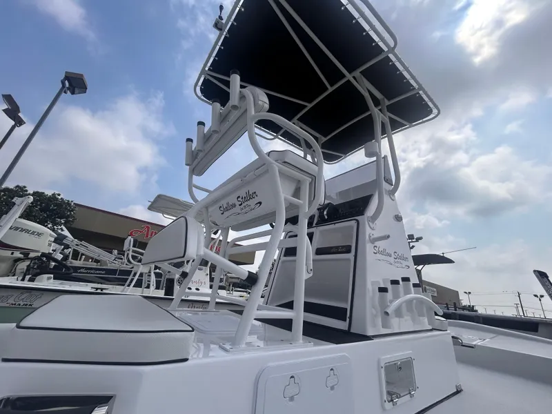 Slide: The Image of 2025 Shallow Stalker CAT211PRO boat with elevated seating and canopy under a cloudy sky. - 7