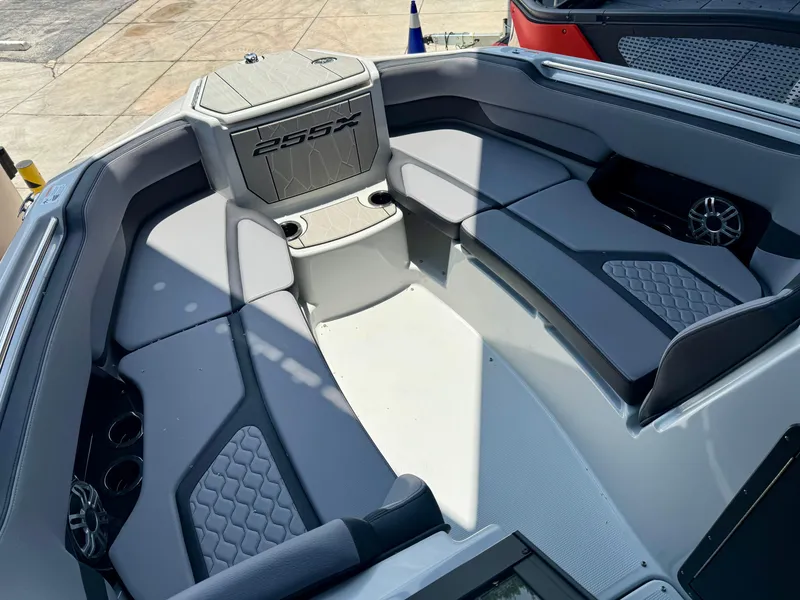 Slide: The Image of 2025 Yamaha Boats 255XD interior with gray seating and cup holders. - 13